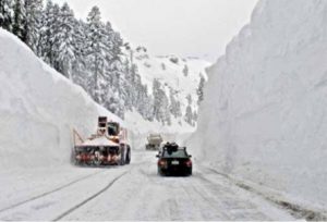 Snowy highway with snow plow